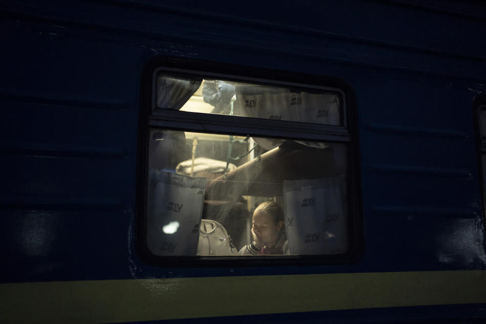 A woman sits in an evacuation train in Sumy, Ukraine, Thursday, Nov. 23, 2023. An average of 80-120 people return daily to Ukraine from territories held by Russia through an unofficial crossing point between the two countries amid a brutal war. Most choose this challenging path, even in freezing temperatures, to escape Russian occupation and reunite with their relatives in Ukraine. (AP Photo/Hanna Arhirova)