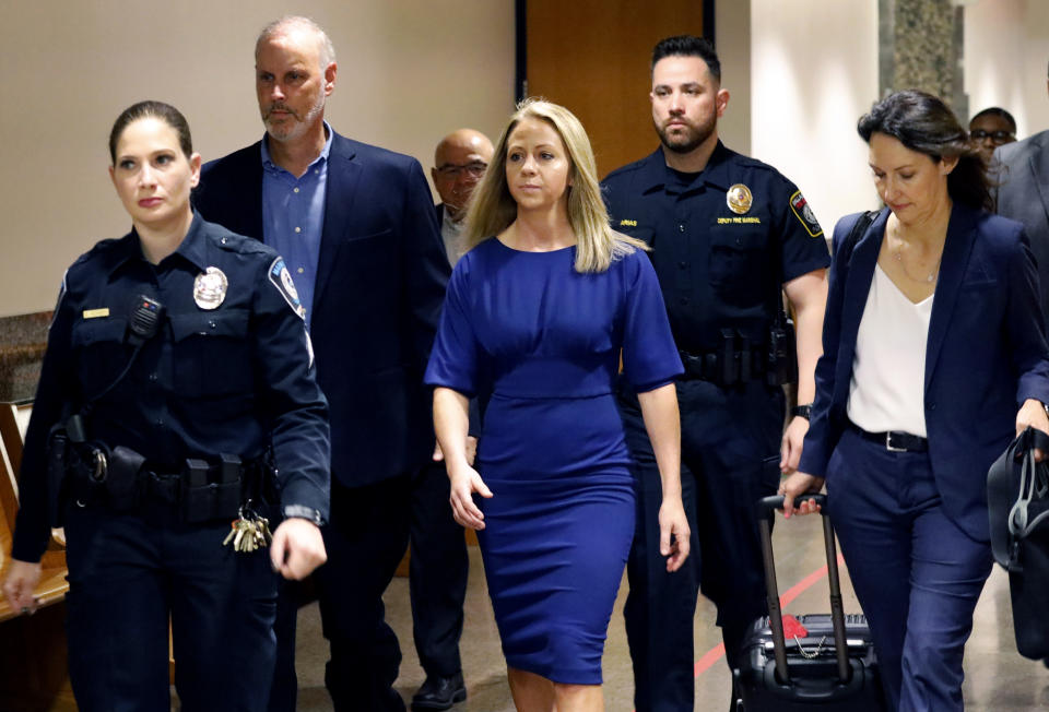 Former Dallas police officer Amber Guyger, center, arrives for the first day of her murder trial in the 204th District Court at the Frank Crowley Courts Building in Dallas, Monday, Sept. 23, 2019. Guyger is accused of shooting her black neighbor in his Dallas apartment. (Tom Fox/The Dallas Morning News via AP, Pool)
