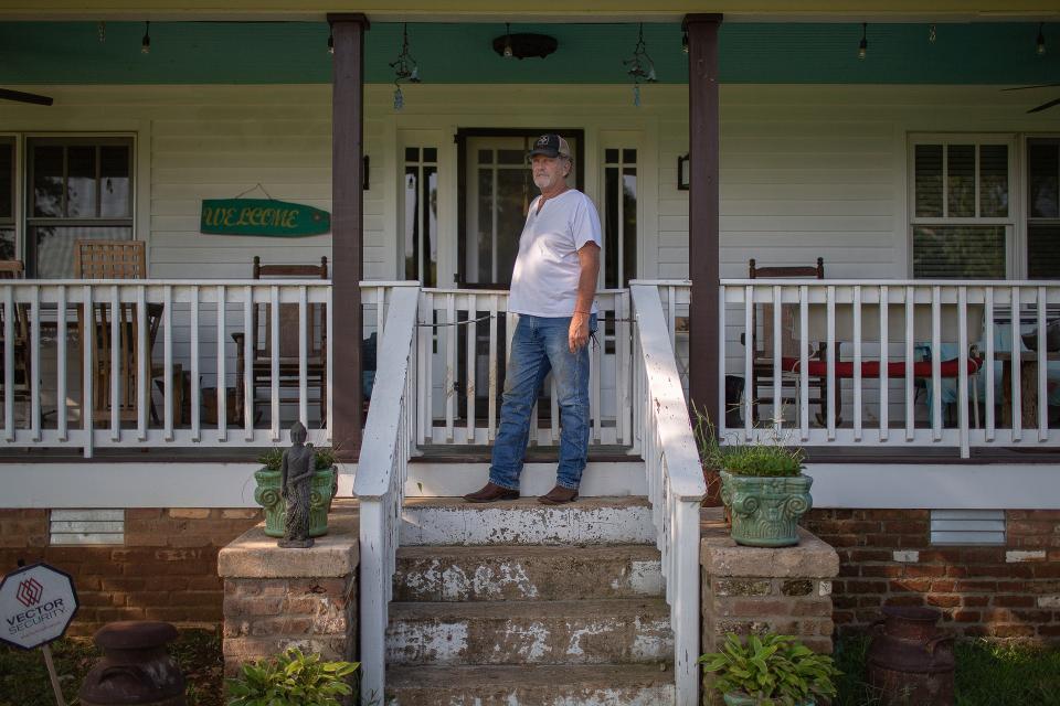 Lee McCormick stands on the porch of his family farm near  Nunnelly, Tenn., on Tuesday, Aug. 24, 2021.