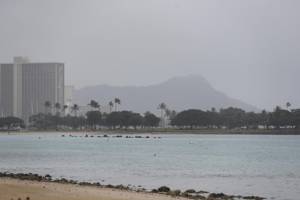 Diamond Head mountain is shrouded in rain, Monday, Dec. 6, 2021, in Honolulu. (AP Photo/Marco Garcia)