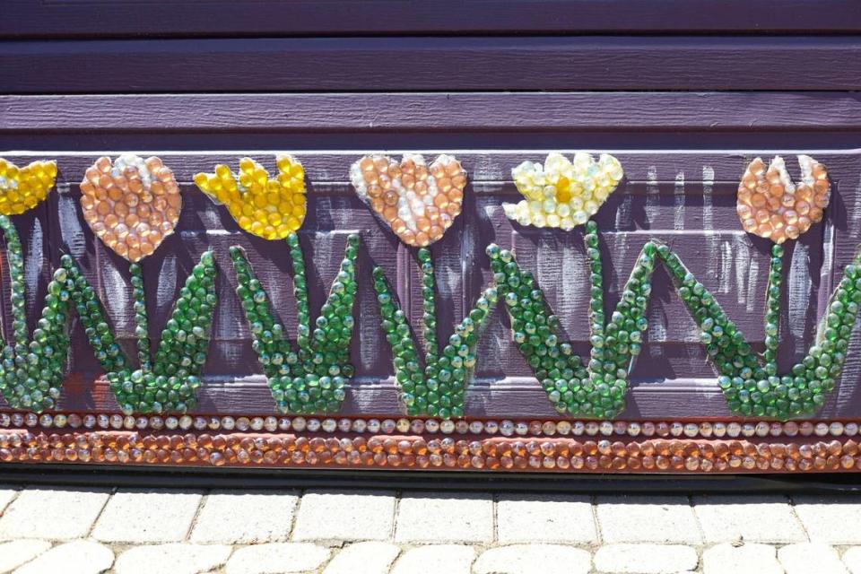 Mosaic tiles of tulips accent the garage door of the San Luis Obispo home owned by Bruce and Suki Mason, seen here on May 10, 2024.