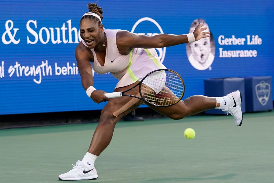 Serena Williams hits a forehand to Emma Raducanu during the Western & Southern Open.