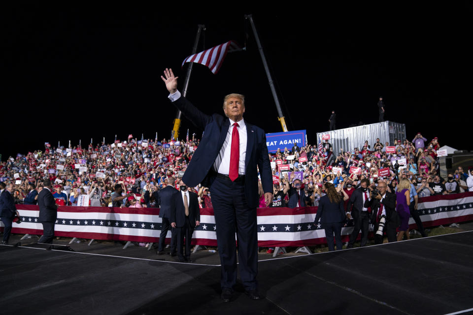 President Donald Trump waves to the crowd as he walks off stage after speaking at a campaign rally at Gastonia Municipal Airport, Wednesday, Oct. 21, 2020, in Gastonia, N.C. (AP Photo/Evan Vucci)