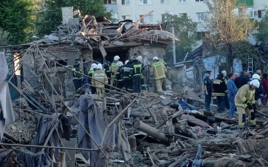 Rescue specialists work at the site of a destroyed residential building after the blasts in Belgorod, Russia, on July 3 - Belpressa/Reuters