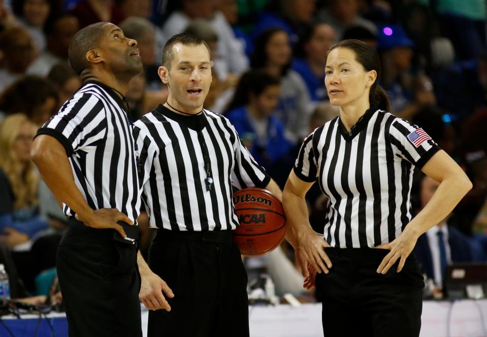 In this Sunday, March 5, 2017, photo, officials Eric Brewton, left, Joe Vaszily, center, and Maj Forsberg stand together during a timeout during the women's basketball game between Duke and Notre Dame.