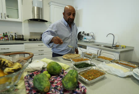 Berhanu Nega, an exiled Ethiopian Ginbot 7 rebel leader prepares lunch in his apartment after a Reuters interview in Addis Ababa, Ethiopia October 19, 2018. Picture taken October 19, 2018. REUTERS/Tiksa Negeri