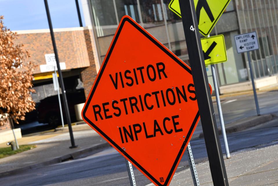 A sign highlights restrictions due to COVID-19 Wednesday, Dec.1, 2021, near an entrance at the St. Cloud Hospital.