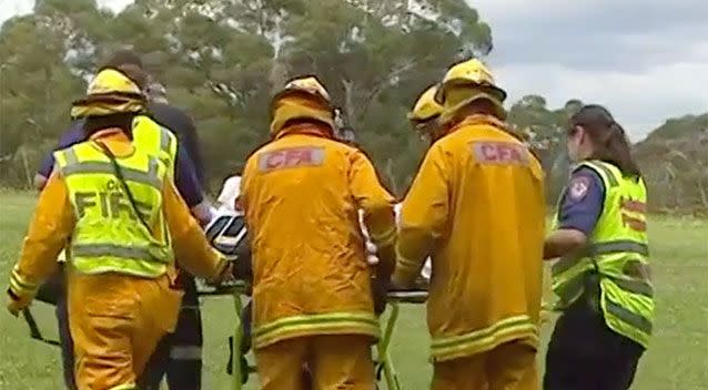 Paramedics transport the 68-year-old woman. Source: 7 News