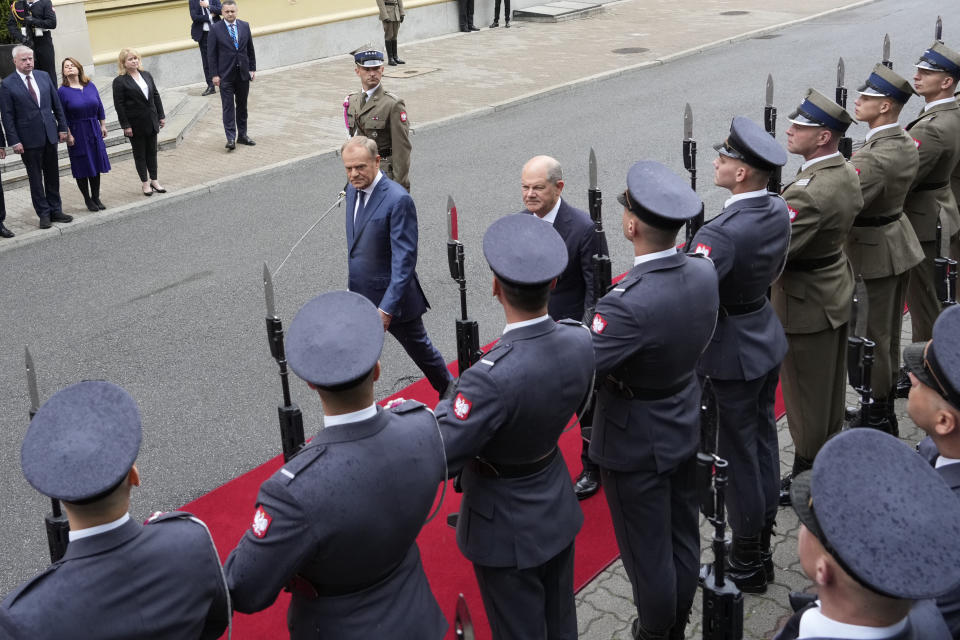 German Chancellor Olaf Scholz, center right, and Polish Prime Minister Donald Tusk review the guard of honor before German-Polish inter-governmental consultations in front of Prime Minister Chancellery in Warsaw, Poland, Tuesday, July 2, 2024. (AP Photo/Czarek Sokolowski)