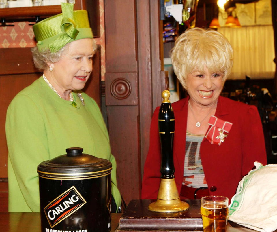 FILE PHOTO: Britain's Queen Elizabeth visits the set of BBC soap opera Eastenders with actress Barbara Windsor, in London, Britain November 28, 2001. REUTERS/Fiona Hanson/POOL/File Photo