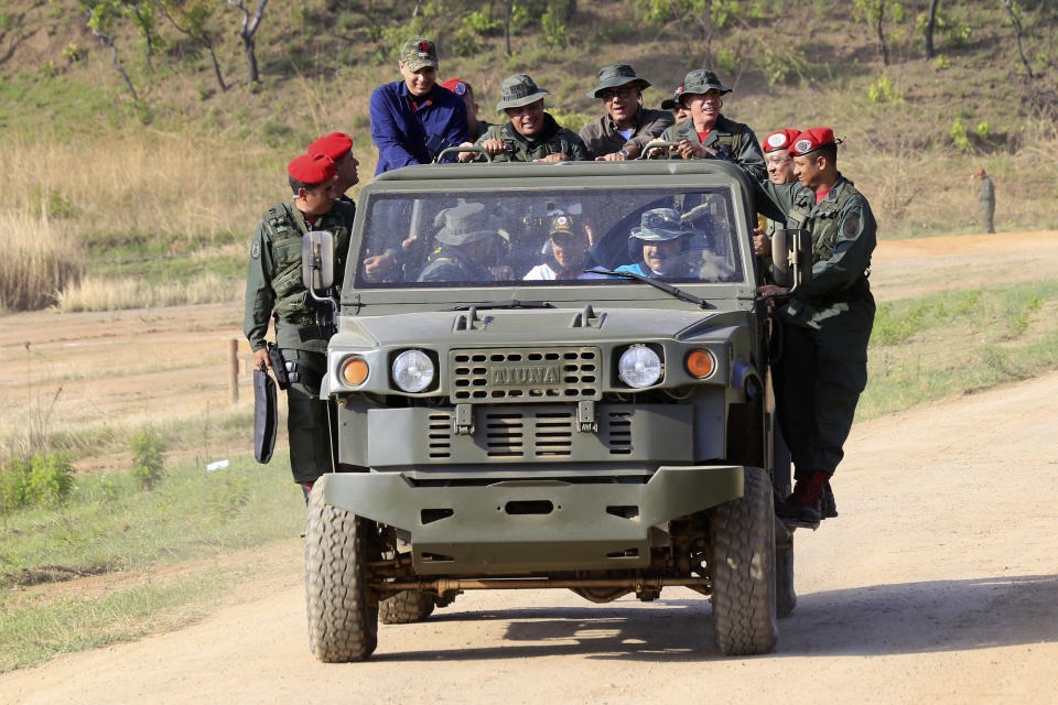 In this handout photo released by Miraflores Press Office, Venezuela's President Nicolas Maduro drives a military vehicle at the G/J José Laurencio Silva training center in the state of Cojedes, Venezuela, Saturday, May 4, 2019. (Jhonn Zerpa/Miraflores Press Office via AP)