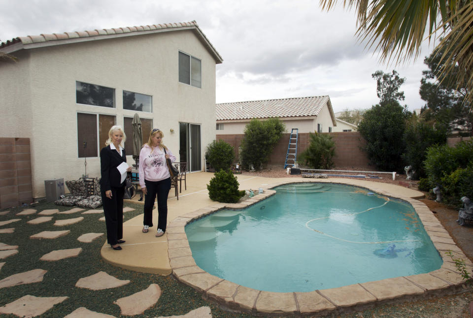 Fafie Moore (L), a Reality Executives owner/broker, and realtor Helen Riley look over the backyard of a home being offered for sale in Henderson, Nevada April 8, 2013. Moore says private-equity firms and hedge funds have largely "crowded out" local buyers since investment firms began buying homes here some eight months ago. Picture taken April 8, 2013. For use with Special Report VEGAS-HOUSING/   REUTERS/Steve Marcus (UNITED STATES - Tags: BUSINESS CONSTRUCTION REAL ESTATE)