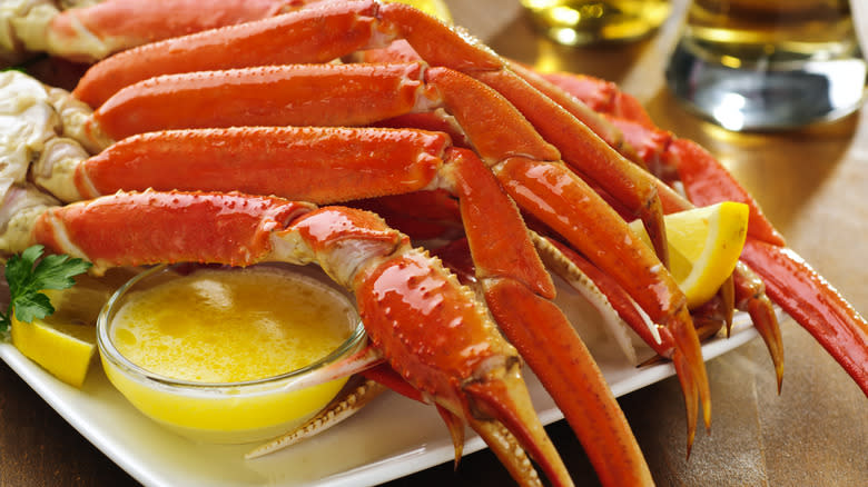 crab legs on plate with a dish of melted butter