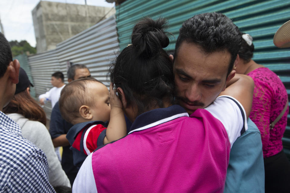 A Guatemalan migrant, who was deported from the United States, embraces relatives after arriving at the Air Force Base in Guatemala City, Tuesday, July 16, 2019. Nearly 200 Guatemalan migrants have been deported on Tuesday, the day the Trump administration planned to launch a drastic policy change designed to end asylum protections for most migrants who travel through another country to reach the United States. (AP Photo/Moises Castillo)