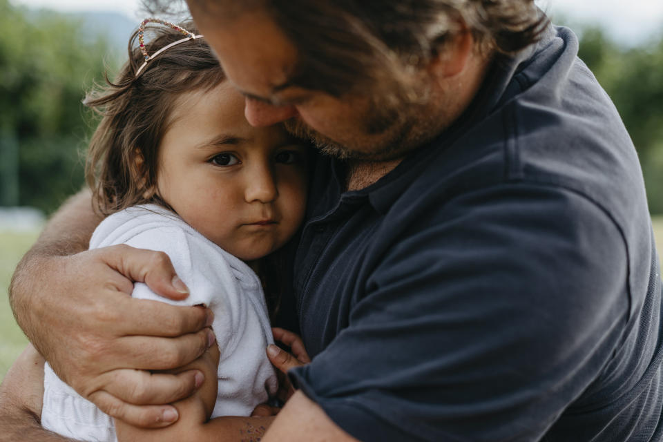 Man hugging a young girl