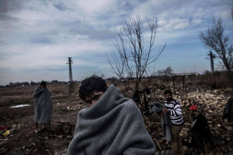 <p>A Pakistani migrant covers himself with a blanket after taking a bath in the yard of an abandoned brick factory at the outskirts of Subotica, border town with Hungary in Serbia, Feb. 1, 2017. (Manu Brabo/MeMo) </p>