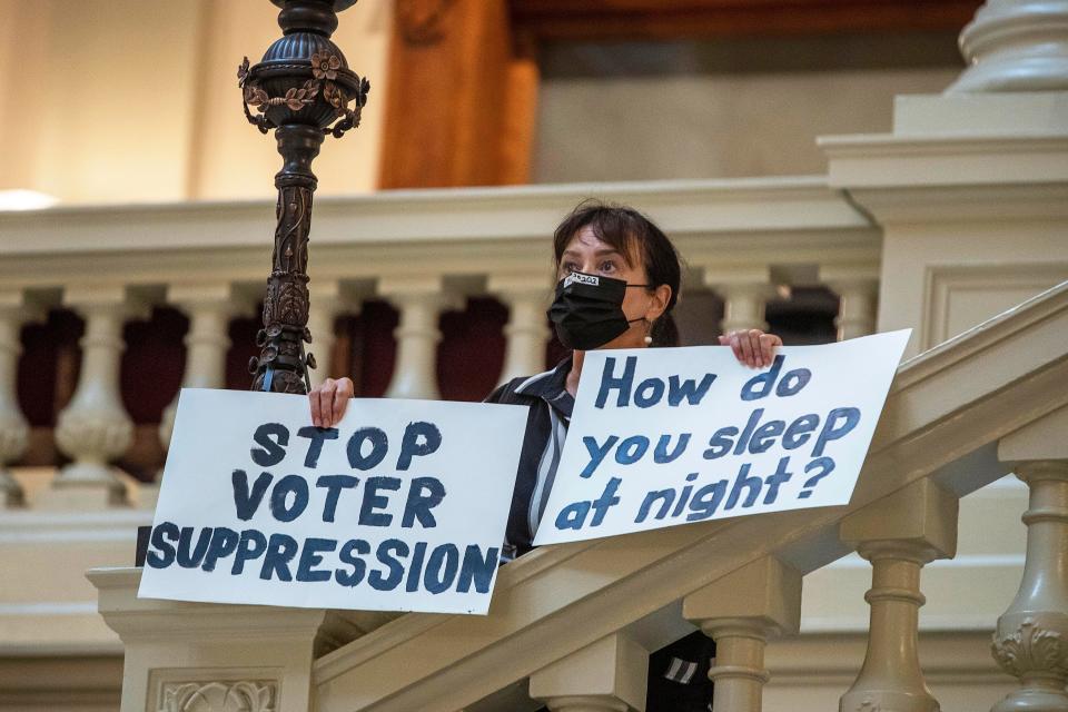 Ann White demonstrates at the Georgia State Capitol building after lawmakers passed an overhaul of state election laws.