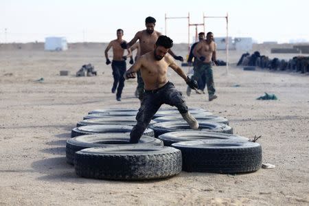 Sunni volunteers, who have joined the Abbas Fighting Division, take part in a field training in Kerbala, Iraq December 20, 2017. Picture taken December 20, 2017. REUTERS/Thaier Al-Sudani