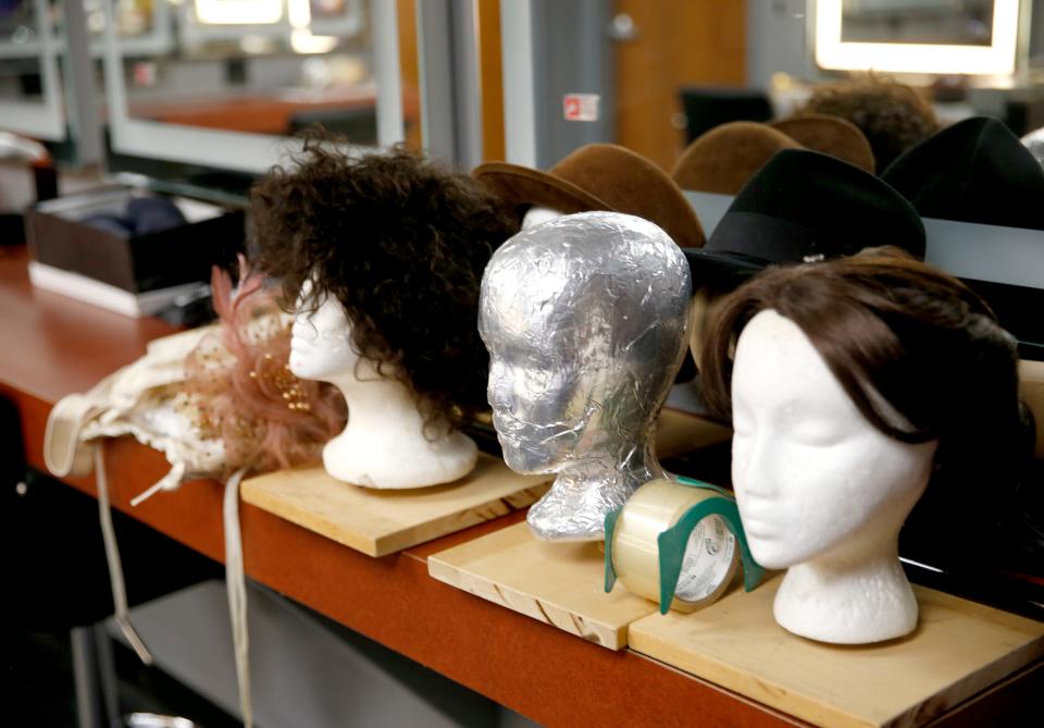 Wigs are displayed in a dressing room before a rehearsal for Steve Martin's "Picasso at the Lapin Agile" at the new Carpenter Square Theatre in Oklahoma City.