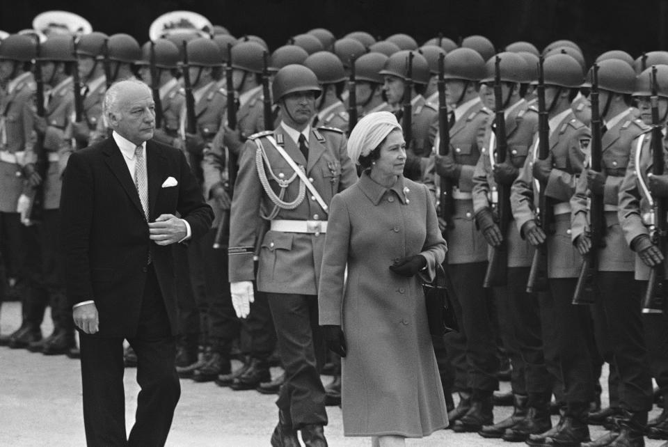 FILE - Britain's Queen Elizabeth II and West German President Walter Scheel inspect honor guards of the West German army in Bonn on May 22, 1978, when Queen Elizabeth arrived for a five-day state visit to West Germany. One would like two horses. That, in effect, was the gift requested by Queen Elizabeth II during her state visit to Germany in 1978, weekly Der Spiegel reported Monday, March 27, 2023. (AP Photo, File)