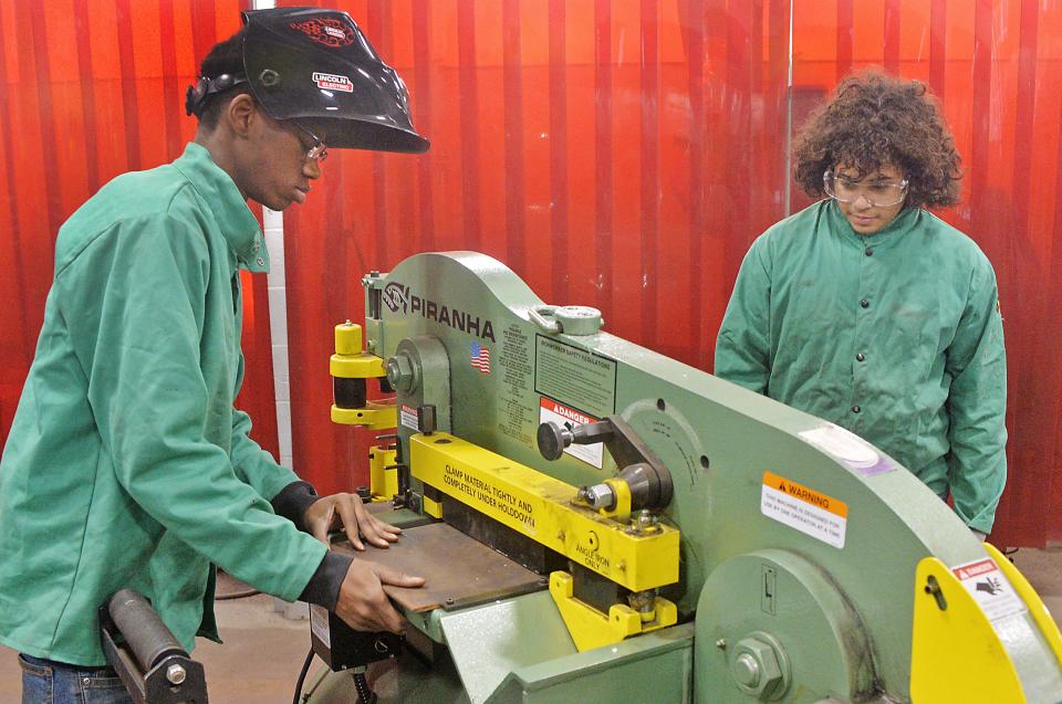 Erie High School freshman Jaiviyn Gaines, 14, left, and sophomore Luis Velez, 15, practice cutting steel plates during a career and technical education class on Jan. 5.