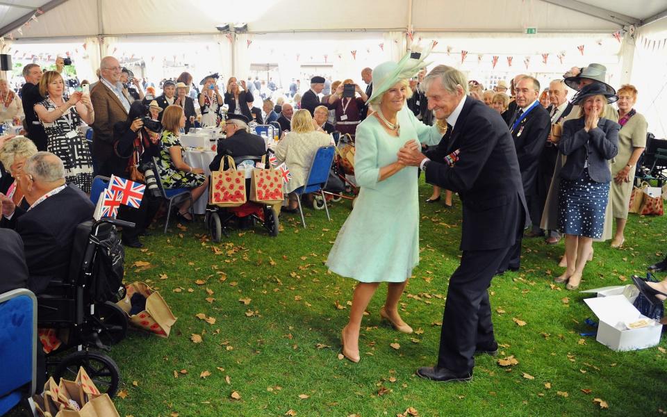 August 2015: The Duchess of Cornwall, as she then was, dances with Jim Booth during 70th Anniversary commemorations of VJ Day in College Garden, Westminster Abbey - Eamonn McCormack/Getty Images