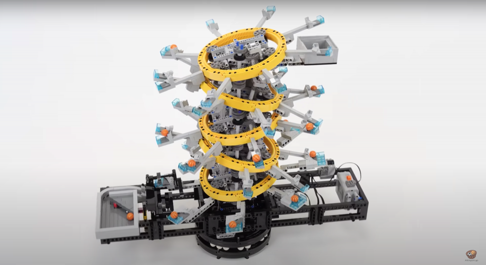 Small, toy basketballs moving their way down a pointless yet beautiful LEGO machine.