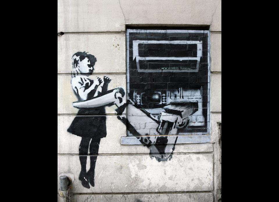 LONDON - MAY 18:  A spray painted depiction of a cash machine grabbing a child adorns a wall in Exmouth Market on May 18, 2007 in London.  (Photo by Peter Macdiarmid/Getty Images)