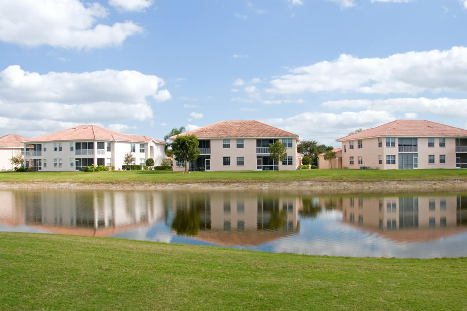 townhomes on a golf course across a pond