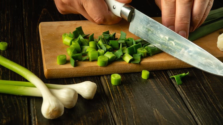 green garlic being chopped