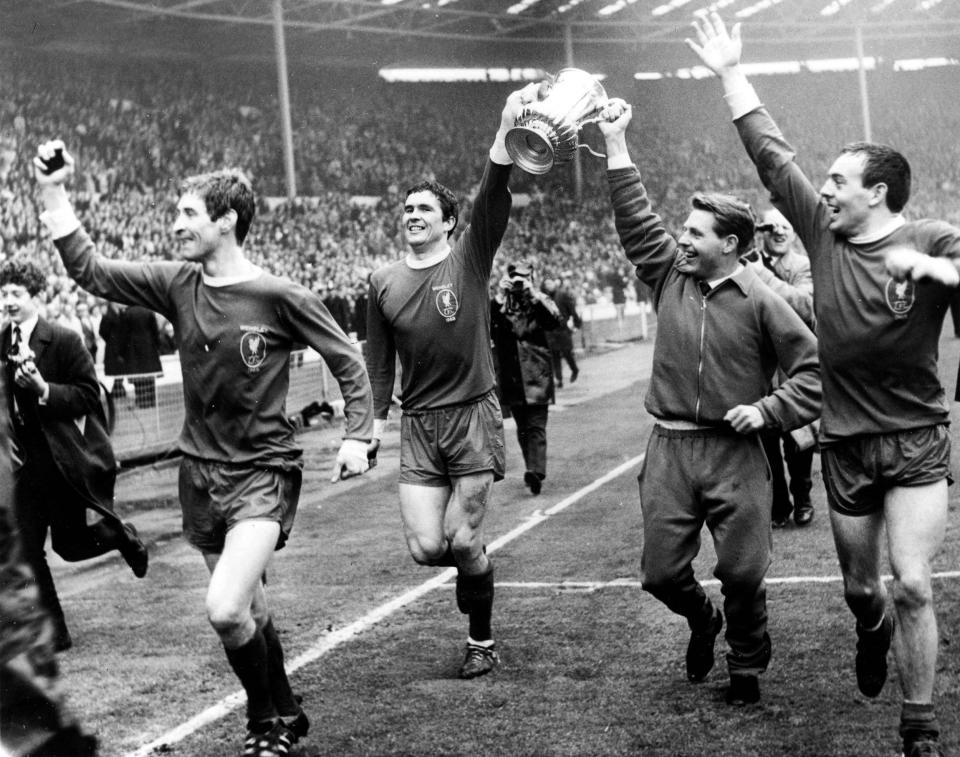 St John, right, celebrates Liverpool's FA Cup victory with his teammates, l-r, Geoff Strong, Ron Yeats and Gordon Milne - Popperfoto via Getty Images