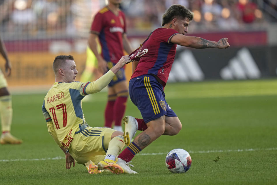 New York Red Bulls forward Cameron Harper (17) pulls the jersey of Real Salt Lake midfielder Diego Luna, right, during the first half of an MLS soccer match Saturday, July 15, 2023, in Sandy, Utah. (AP Photo/Rick Bowmer)