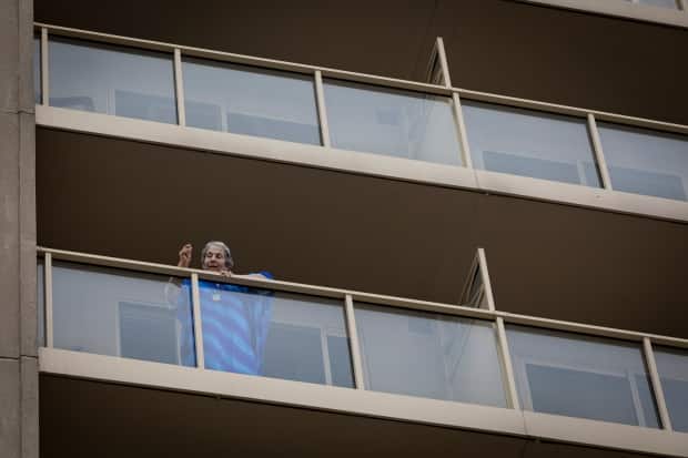 Barb Horowitz waves to her grandson from her balcony at Amica Thornhill. He says before regular activities were cancelled at the retirement home, she enjoyed exercise classes, movie and trivia nights, and playing cards with friends.