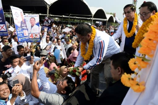 Palang Pracharat party leader Uttama Savanayana (R) is greeted by supporters during a campaign rally in Narathiwat