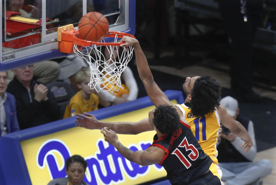 The ball bounces out of the rim as Louisville's David Johnson (13) misses a dunk next to Pittsburgh's Justin Champagnie during the second half of an NCAA college basketball game Tuesday, Jan. 14, 2020, in Pittsburgh. (AP Photo/Keith Srakocic)