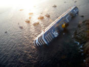 View of the Costa Concordia on January 14, 2012, after the cruise ship ran aground and keeled over off the Isola del Giglio, last night. Three people died and several were missing after the ship with more than 4,000 people on board ran aground sparking chaos as passengers scrambled to get off. The ship was on a cruise in the Mediterranean, leaving from Savona with planned stops in Civitavecchia, Palermo, Cagliari, Palma, Barcelona and Marseille," the company said. AFP PHOTO / FILIPPO MONTEFORTE