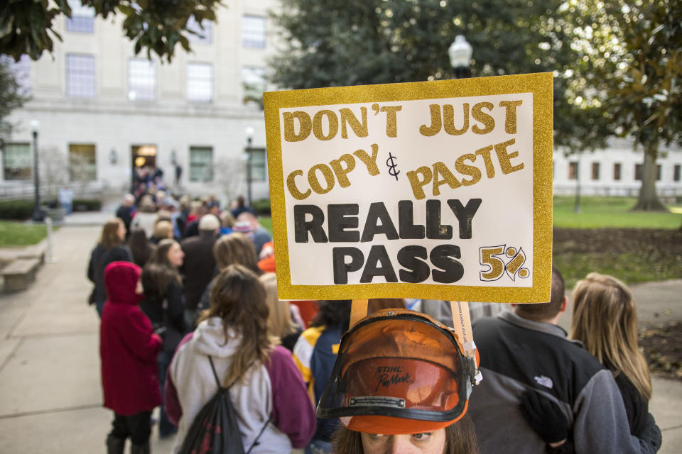 <p>Vanessa Brown, a teacher from Cledenin W.Va., holds a sign with her hat as she waits to get into a teacher rally Monday, March 5, 2018, at the West Virginia Capitol in Charleston, W.Va. (Photo: Tyler Evert/AP) </p>