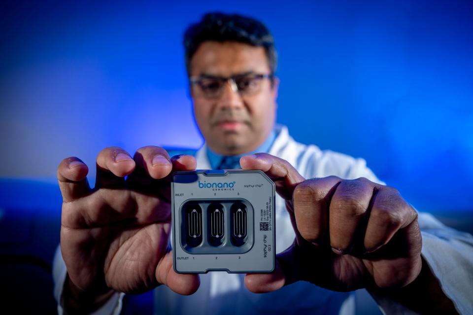 Dr. Ravindra Kolhe, director of the Georgia Esoteric & Molecular Laboratory, holds a Bionano Genomics flow cell cartridge that will be loaded with genetic material from COVID-19 patients and then analyzed to determine if there is a genetic reason why some patients get very sick or die. 1/24/22