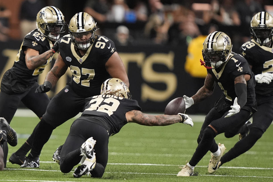 New Orleans Saints safety Tyrann Mathieu (32) recovers a fumble by the Carolina Panthers during the first half of an NFL football game Sunday, Sept. 8, 2024, in New Orleans. (AP Photo/Gerald Herbert)