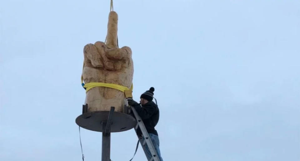 A disgruntled small business owner built a 5m statue of a hand flipping the bird as a message town officials who rejected his application to build a garage on his property. Source: Ted Pelkey