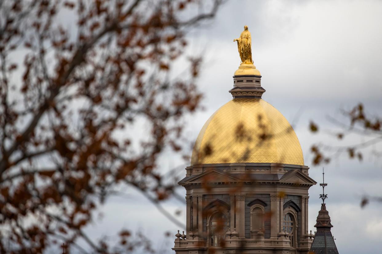 The Virgin Mary atop the "Golden Dome" on the Administration Building is seen through nearly bare trees before an NCAA college football game between Notre Dame and Pittsburgh on Saturday, Oct. 28, 2023, in South Bend.