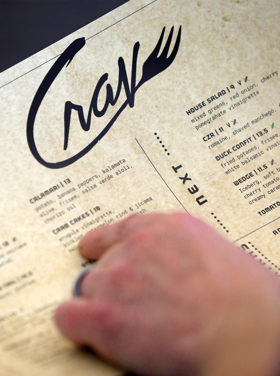 Crave owner/chef Aaron Hervey goes over the menu on Thursday.