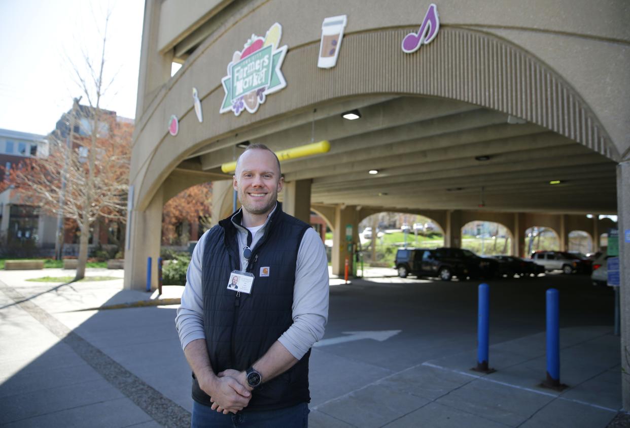 Iowa City’s new Farmers’ Market Supervisor Bill Lane stands in front of the Chauncey Swan Parking Ramp that houses the market Friday, April 12, 2024 in downtown Iowa City.