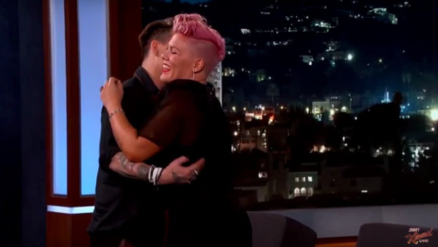 Johnny proved a good sport and gave Pink a warm hug. Source: YouTube