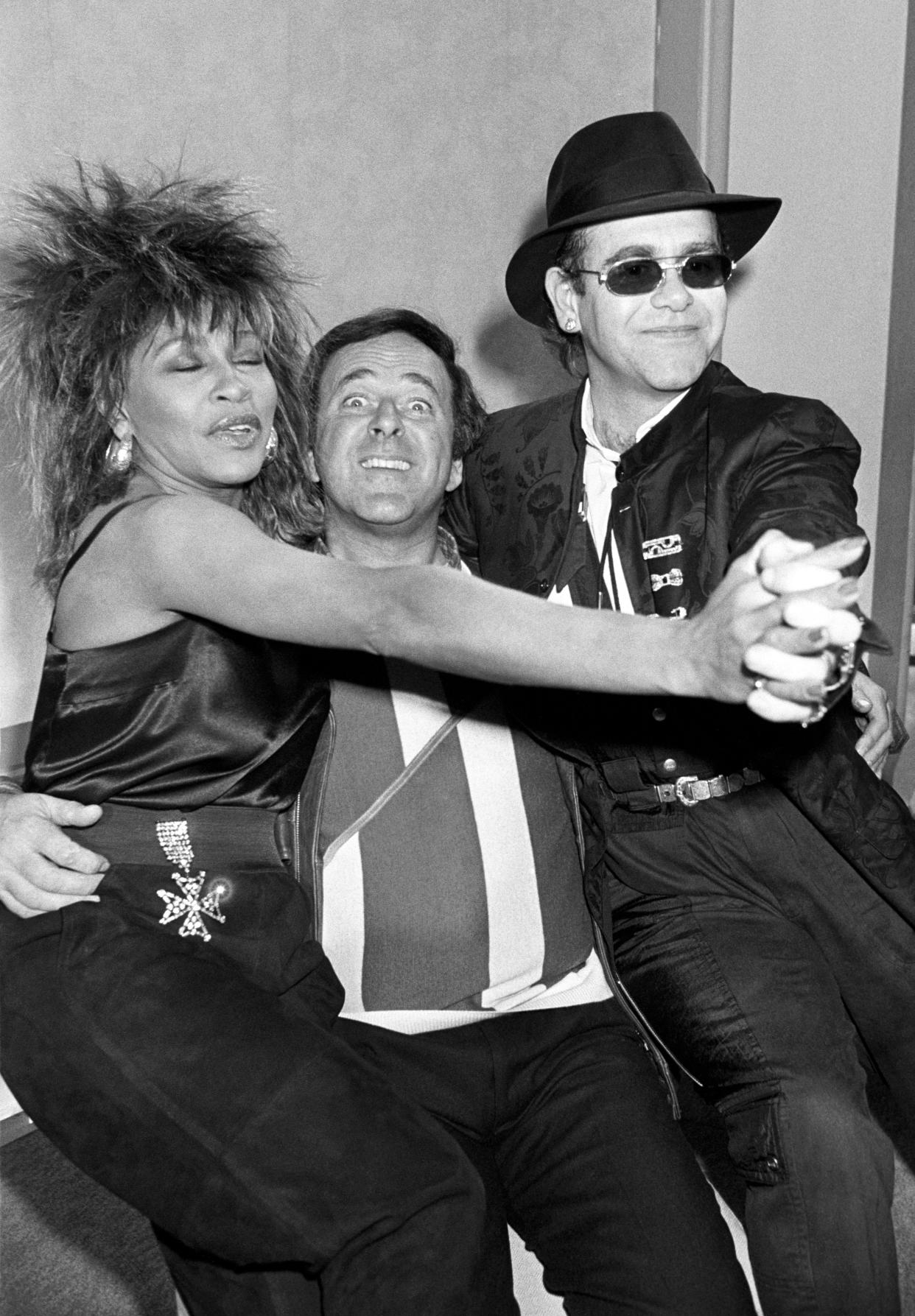 1985: Chat Show host Terry Wogan (c) with American singer Tina Turner and pop star Elton John at the BBC TV centre in Shepherds Bush, London, two of the guests for his new 3 times a week chat show series.  CELEBRITY   (Photo by PA Images via Getty Images)