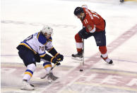 Florida Panthers left wing Jonathan Huberdeau (11) skates around St. Louis Blues left wing Brandon Saad (20) during the first period of an NHL hockey game Saturday, Dec. 4, 2021, in Sunrise, Fla. (AP Photo/Jim Rassol)