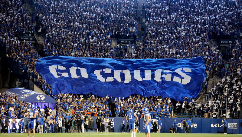 Fans cheer as the Brigham Young Cougars play the Cincinnati Bearcats in a football game at LaVell Edwards Stadium in Provo on Friday, Sept. 29, 2023.