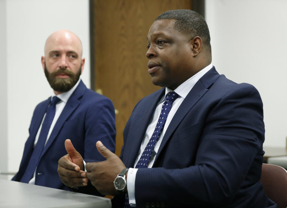 In this Wednesday, June 19, 2019 photo, attorney Jonathan Cox responds to a question during an interview as Eric Ridenhour, left, listens in Dallas, Wednesday, June 19, 2019. Ridenhour's fiancee was killed in the June 9 crane collapse in downtown Dallas. (AP Photo/Tony Gutierrez)