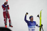 Iivo Niskanen, of Finland, right, celebrates after finishing ahead of Alexander Bolshunov, of the Russian Olympic Committee, left, during the men's 15km classic cross-country skiing competition at the 2022 Winter Olympics, Friday, Feb. 11, 2022, in Zhangjiakou, China. (AP Photo/Aaron Favila)