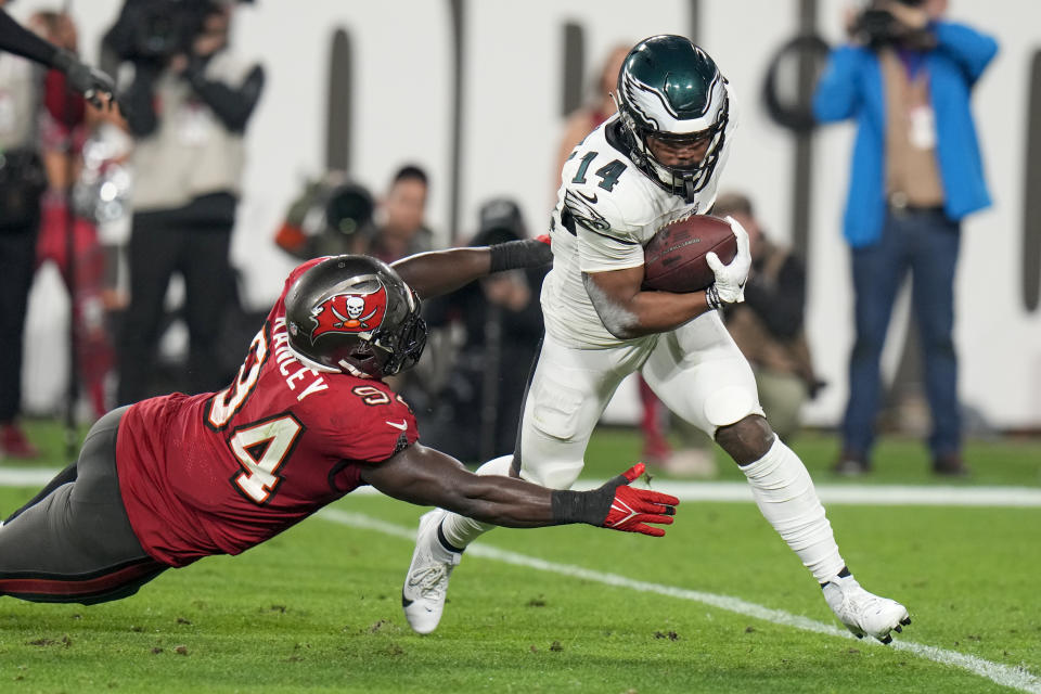 Philadelphia Eagles running back Kenneth Gainwell (14) avoids tackle by Tampa Bay Buccaneers defensive tackle Calijah Kancey (94) during the second half of an NFL wild-card playoff football game, Monday, Jan. 15, 2024, in Tampa, Fla. (AP Photo/Chris O'Meara)